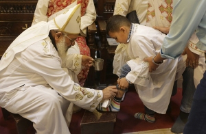 A Coptic Christian Clergyman washes the feet of a congregation member in Egypt... image courtesy of http://english.ahram.org.eg/NewsContentMulti/99368/Multimedia.aspx